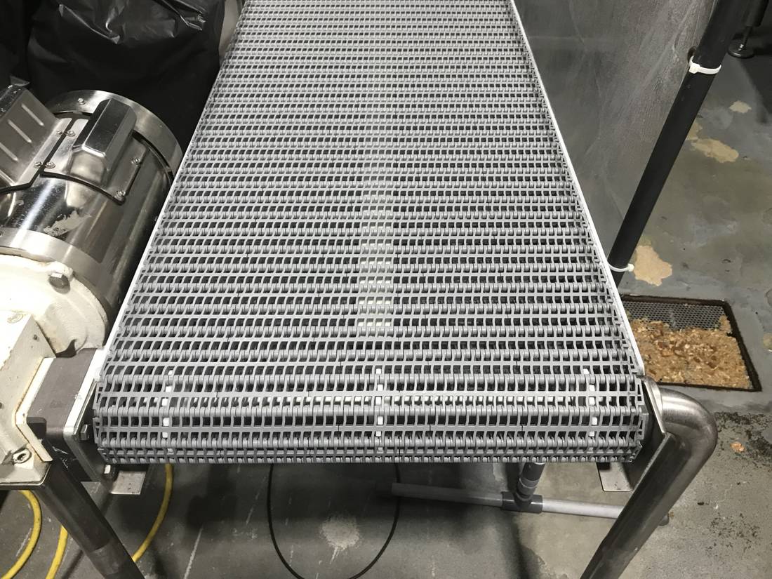 Gray modular plastic belt conveyor with a stainless washdown motor