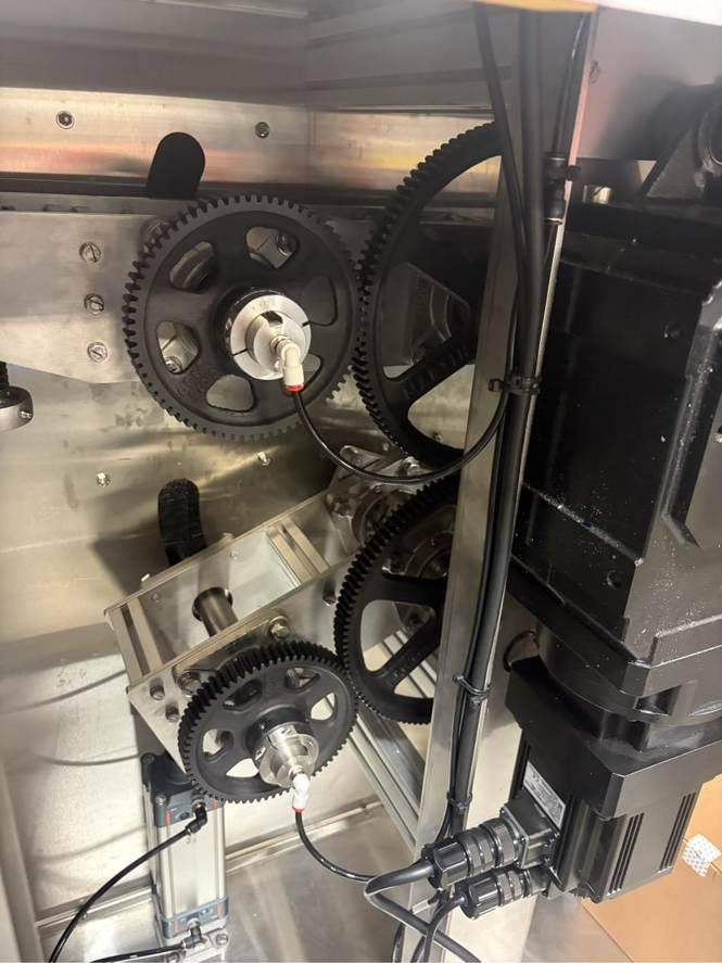 Servo motor driving a gear train