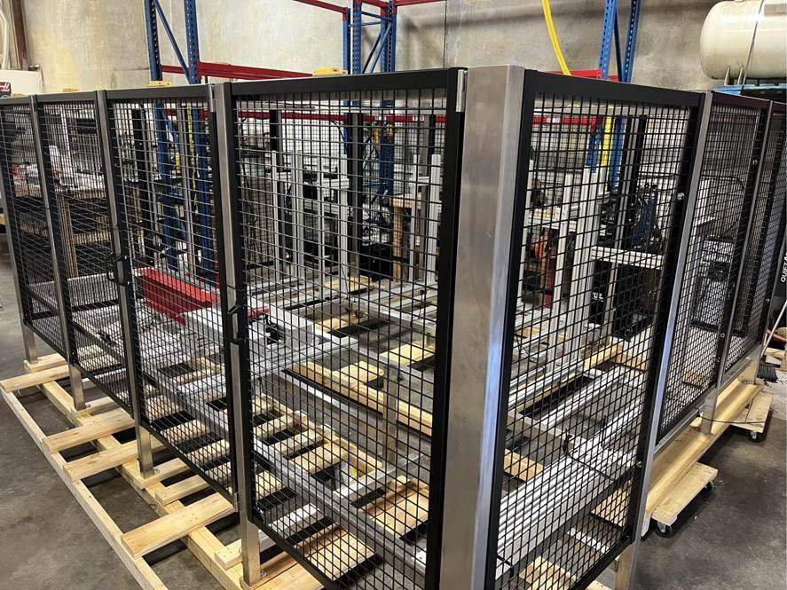 Black mesh machine guarding around an automation cell
