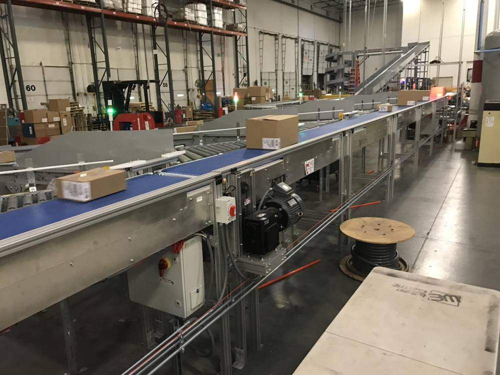 Long belt sorter with divert lanes in a warehouse