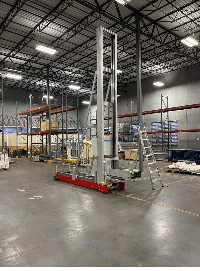 Tall aluminum gantry on a red mobile base