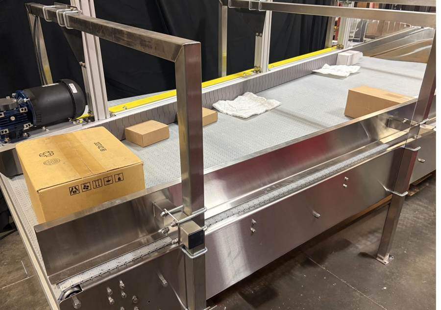 Stainless steel conveyor carrying cartons
